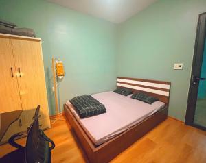 a bedroom with a bed in a room at Êm Tiny in Hai Phong