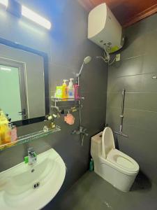 a bathroom with a toilet and a sink and a mirror at Êm Tiny in Hai Phong +15 photos