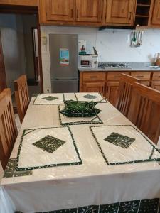 a kitchen with a table with a table cloth on it at APPARTEMENT Saly in Abomey-Calavi +3 photos