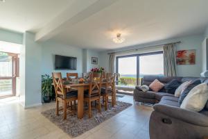 a living room with a table and a couch at Ty-Mari in Harlech