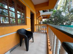 a bar with a black chair on a balcony at Aura Calangute in Calangute