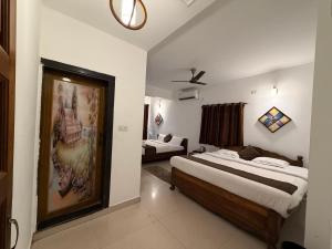 a bedroom with a bed and a couch in it at Aura Calangute in Calangute
