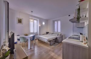 a living room with a bed and a table at In centro Ca' Leandro Vista lago in Lierna +28 photos
