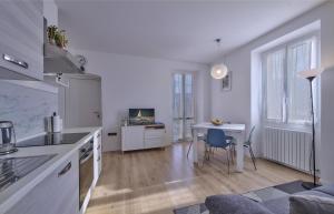 a kitchen with a table and a desk with a computer at In centro Ca' Leandro Vista lago in Lierna