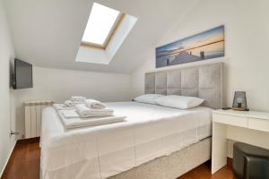 a bedroom with a large white bed with a window at Garni Hotel Milica in Herceg-Novi +94 photos
