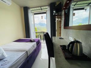 a bedroom with a bed and a table with a tea kettle at Almost Heaven in Talawakele