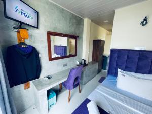 a hotel room with a bed and a mirror at Almost Heaven in Talawakele +50 photos