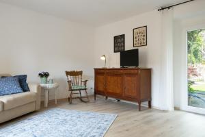 a living room with a couch and a tv on a dresser at Casa La Barancina in Cittiglio