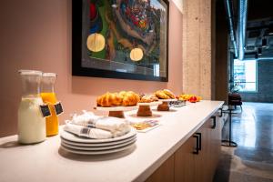 a table with plates of food on a counter at Roami at Century Plaza in Minneapolis
