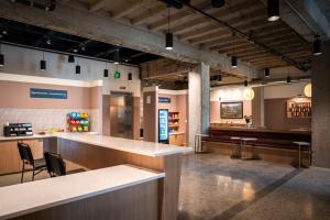 a restaurant with a counter and chairs in a room at Roami at Century Plaza in Minneapolis +28 photos