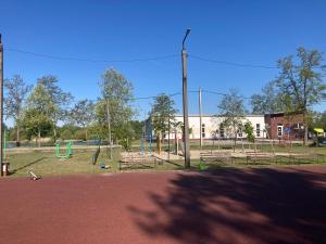 an empty park with benches and a playground at Dunaparti Kuckó in Kiskunlacháza +13 photos