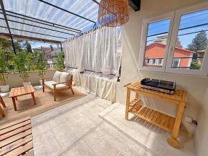 a patio with a table and a chair and a window at L'Esterel Appartements Plage 450m & Gare Saint-Raphael 950m in Fréjus