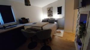a room with a bed and a table and chairs at La Vieille Bastide Suite & Spa in Lorgues