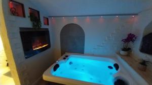 a bath tub in a room with a fireplace at La Vieille Bastide Suite & Spa in Lorgues