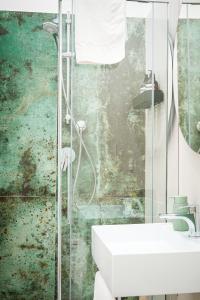 a bathroom with a shower and a white sink at N'Ador Rooms in Naples