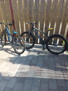 two bikes parked next to each other on a sidewalk at Sunny Quiet Nest in Jūrmala