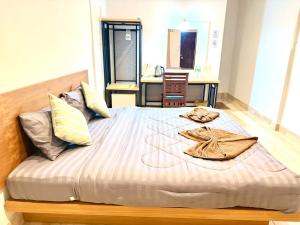a bedroom with a large bed with a robe on it at Full House in Ban Not (1) +4 photos