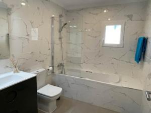 a bathroom with a toilet and a shower and a sink at Villa Aqua Vista in Jávea +26 photos