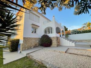 a white house with a staircase in front of it at Villa Aqua Vista in Jávea