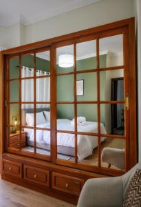 a bedroom with a large wooden cabinet with two beds at Patithries Apartments in Kalymnos