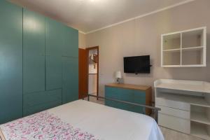 a small bedroom with a bed and a tv at Casa Azzurra in Portoferraio