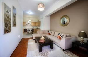 a living room with a couch and a table at Patithries Apartments in Kalymnos