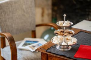 a three tiered dish with seashells on a table at L'Hostellerie de La Licorne in Fontevraud-l'Abbaye +14 photos