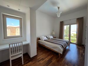 a bedroom with a bed and a window at Beach villa Aurelia in Neo Chorio +53 photos