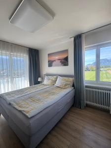 a bedroom with a large bed and windows at Apartment Birnbaum in Wals
