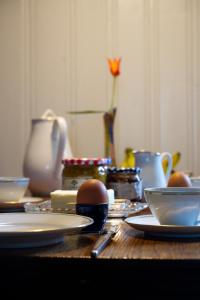 a wooden table with plates and eggs on it at auf der Muehle zwei in Zerbst