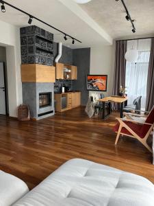 a living room with a couch and a dining room at Котеджі Грань in Yablunytsya