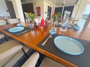 a wooden table with blue plates and utensils on it at Hotel Golchi Palace in Lālsot