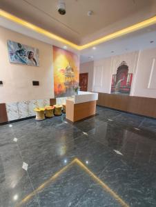 a large room with paintings on the walls and a counter at Hotel Golchi Palace in Lālsot