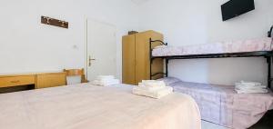 two beds in a room with two bunk beds at Hotel Maria Luisa in Rimini +3 photos