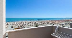 a view of a beach with a lot of umbrellas at Hotel Maria Luisa in Rimini