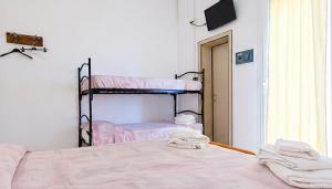 a bedroom with two bunk beds and a mirror at Hotel Maria Luisa in Rimini
