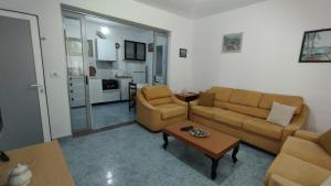 a living room with two couches and a table at Lili's House in Delvinë