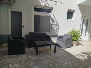 a patio with two chairs and a coffee table at Mejdan II in Mostar