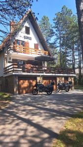 two motorcycles parked in front of a house at Vila Vera in Zlatibor