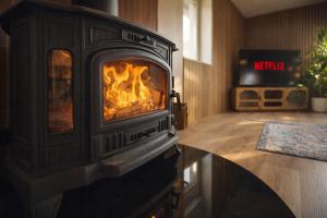 a fireplace in a room with a fire in it at Le lofty in Stoumont