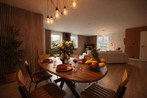 a living room with a wooden table with fruit on it at Le lofty in Stoumont