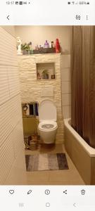 a small bathroom with a toilet and a tub at Saarlouis in Saarlouis