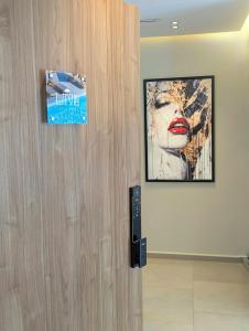 a door with a picture of a woman on the wall at Elite'Stay by Al Amir in Cabo Negro