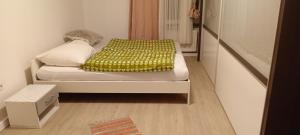 a small white bed in a small room at Saarlouis in Saarlouis