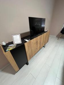 a living room with a television on a wooden table at Apartmani Gala Foča in Foča