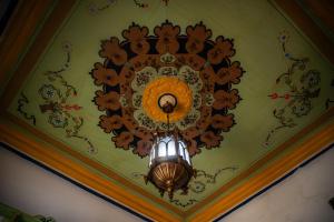 a chandelier hanging from a ceiling with flowers at Dar El Rezk in Tunis