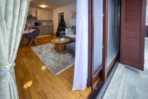 a living room with a couch and a christmas tree at Lake View in Fužine