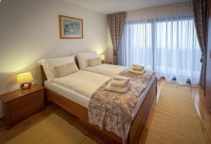 a bedroom with a large bed and a window at Lake View in Fužine