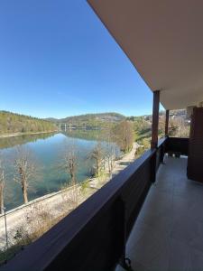 a balcony with a view of a lake at Lake View in Fužine