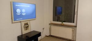 a living room with a flat screen tv on a wall at Saarlouis in Saarlouis